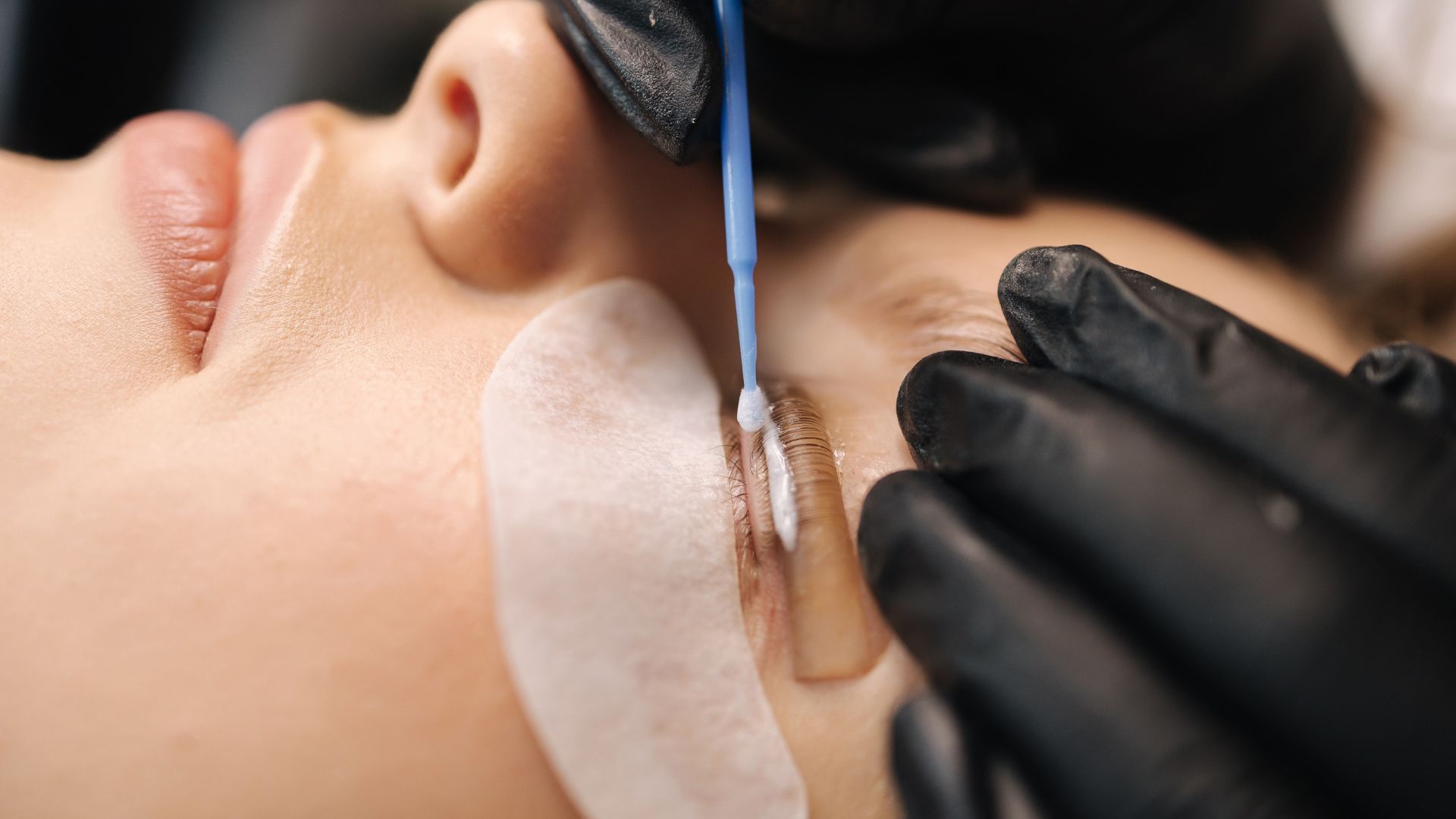 Close-up of the procedure for a patient undergoing a lash lift and tint at an Albuquerque clinic.